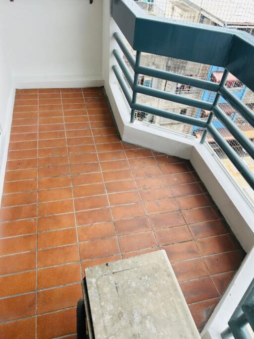 Small balcony with terracotta tiled flooring and railing