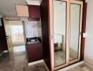 Compact bedroom with built-in wardrobe and kitchenette