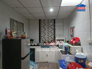 Compact kitchen space with various appliances and utensils