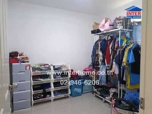 cluttered bedroom with extensive wardrobe and storage units