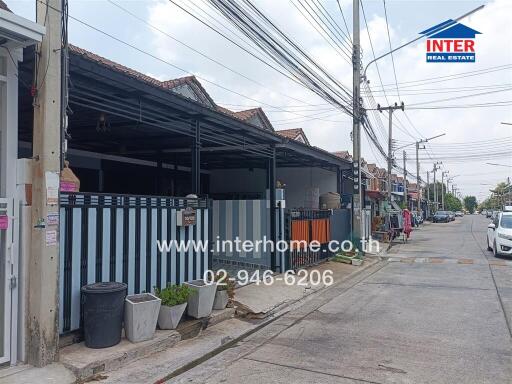 Exterior view of a row of residential and commercial units on a city street