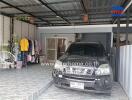 Spacious covered garage with a car and household items