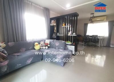 Spacious and well-furnished living room with connected dining area