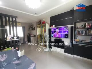 Spacious modern living room with large television and comfortable seating