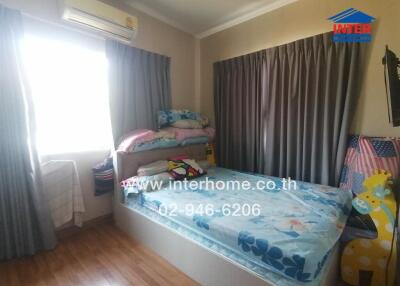 Comfortable and well-lit bedroom with air conditioning
