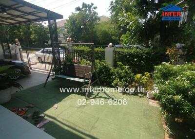 Spacious outdoor area with a swing and well-maintained garden