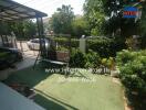 Spacious outdoor area with a swing and well-maintained garden