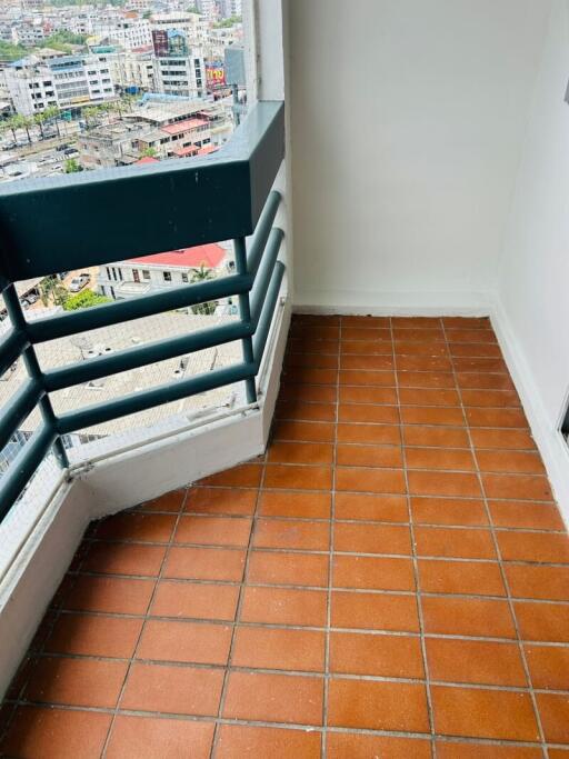 City view from a high-rise apartment balcony with terracotta tiles