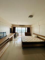 Spacious bedroom with large windows and scenic view