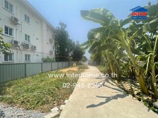 Exterior view of residential building with garden pathway