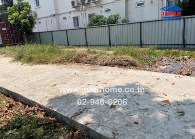 Spacious vacant land with surrounding metal fence