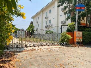 Exterior view of a residential building with a gated entrance