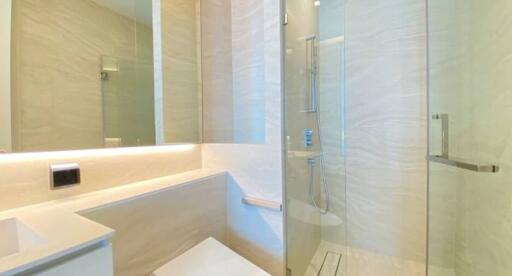 Modern bathroom with glass shower and marble tiles