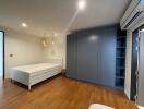 Spacious modern bedroom with large bed and built-in wardrobes