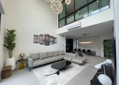 Spacious living room with modern decor and high ceiling