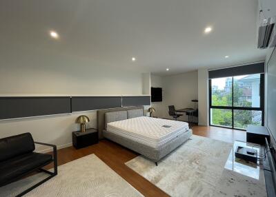 Spacious modern bedroom with large bed and stylish decor