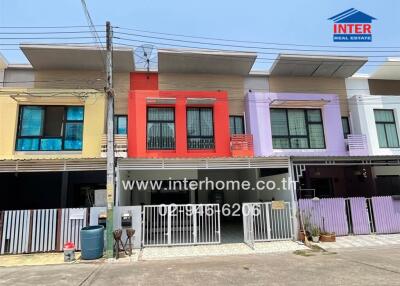 Colorful townhouse exteriors with individual garages