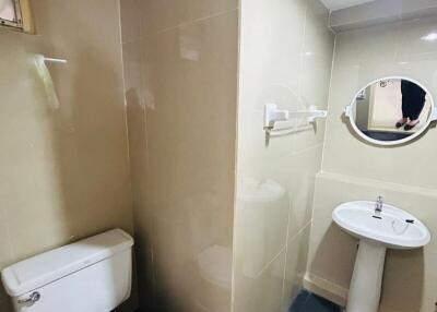 Compact modern bathroom with beige tiles