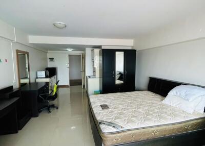 Spacious bedroom with office area and ample natural light