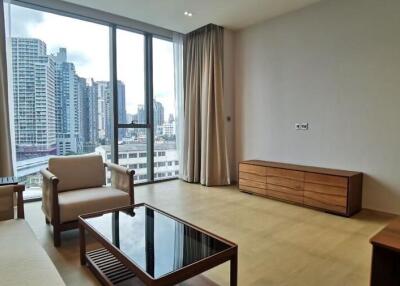 Spacious living room with large windows and city view