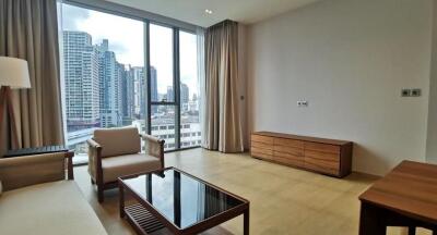 Spacious living room with large windows and city view