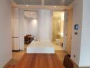 Modern bedroom with en-suite bathroom and wooden flooring