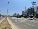 Urban highway with commercial buildings and clear blue sky