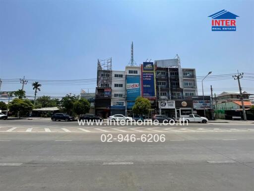 Urban commercial building exterior with visible real estate signage