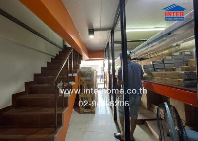 Interior view of a property with staircase and retail display