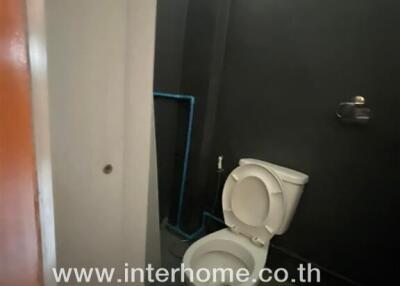 Compact bathroom with visible toilet and mirror