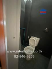 Compact bathroom with visible toilet and mirror