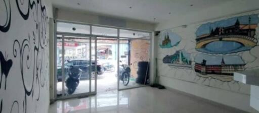 Spacious and artistically decorated lobby with mural and large sliding glass doors