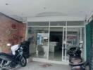 Entrance of a modern residential building with motorcycles parked outside