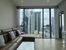 Modern living room with large windows showcasing city views