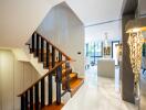 Elegant modern home entryway with stylish staircase and unique lighting fixture