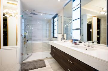 Modern bathroom with double vanity and glass shower