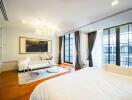 Spacious and elegantly decorated bedroom with large windows and luxurious amenities