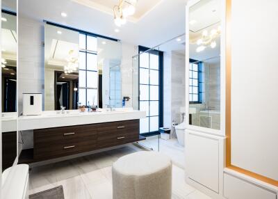 Modern spacious bathroom with large mirrors and elegant decor