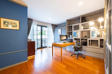 Spacious home office with wooden flooring and modern furniture