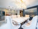 Elegant dining room with chandelier and modern kitchen in the background