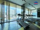 Modern apartment gym with large windows and city view