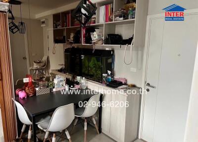 Modern kitchen with dining area and fitted appliances in a compact urban apartment