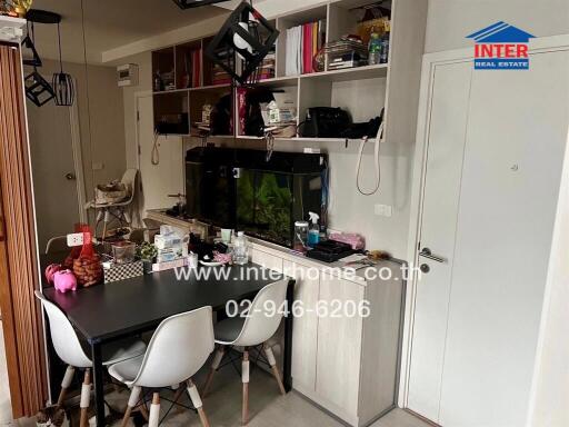 Modern kitchen with dining area and fitted appliances in a compact urban apartment