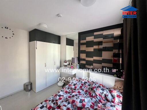Modern styled bedroom with decorative wall and ample storage