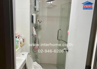 Modern bathroom with shower and neatly organized amenities