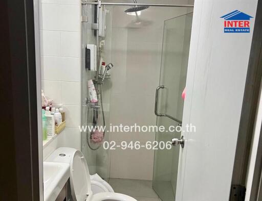 Modern bathroom with shower and neatly organized amenities