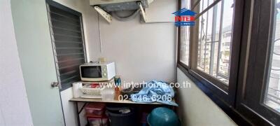 Compact kitchen space with appliances and large window