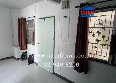 Spacious and Bright Living Room with Large Windows and Security Grills