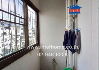 Bright laundry area with large windows and urban view