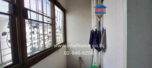 Bright laundry area with large windows and urban view